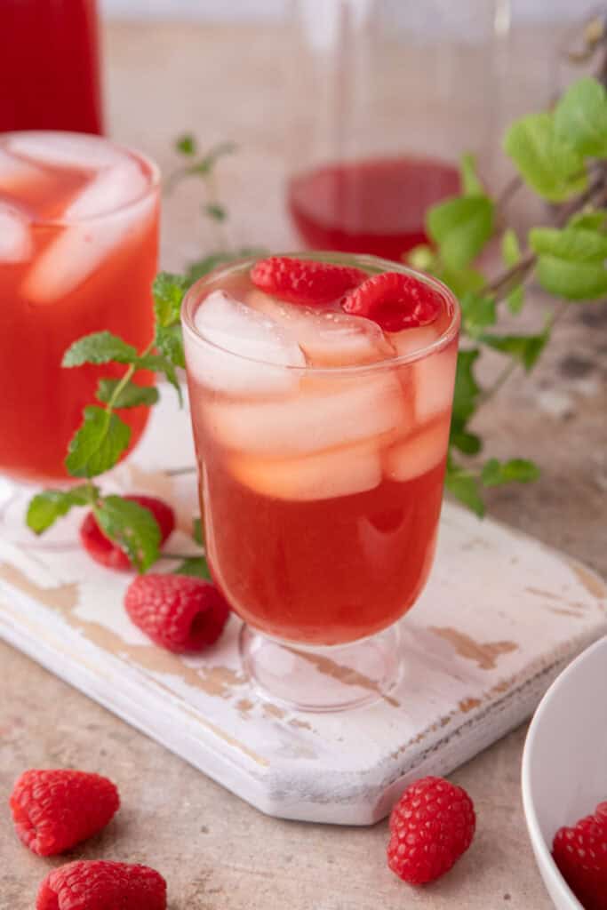 side shot of the raspberry iced tea recipe in a glass of ice