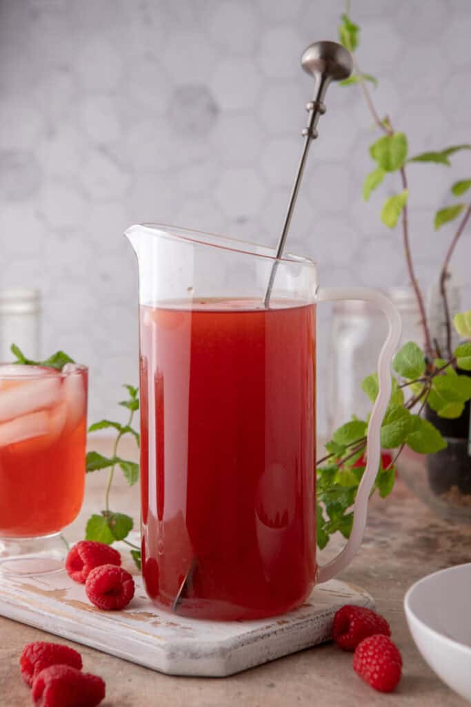 side shot of the raspberry iced tea recipe in a pitcher