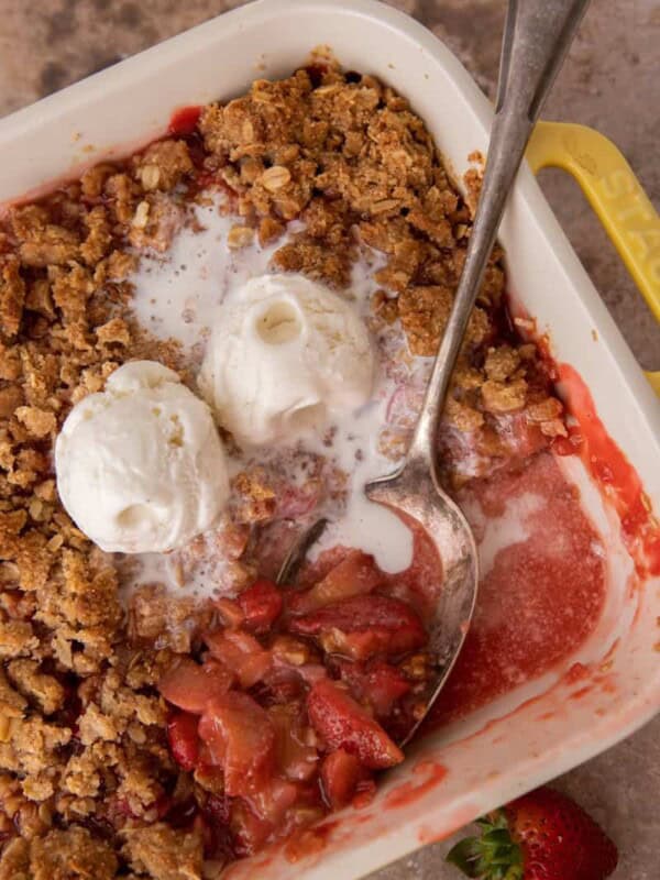 strawberry rhubarb crisp recipe in a baking dish with a spoon