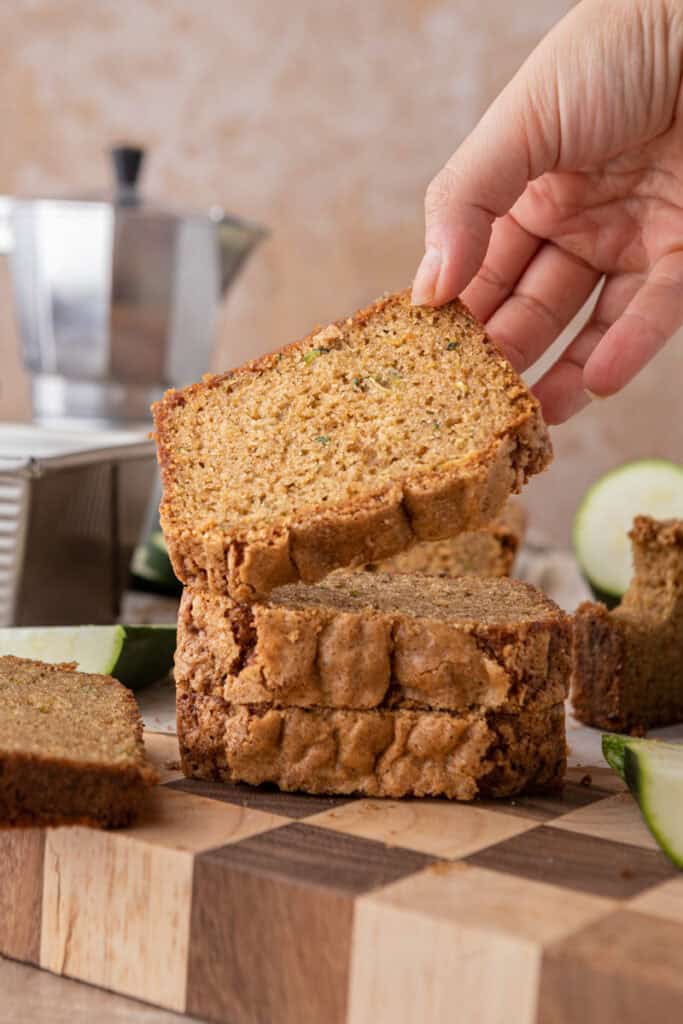 a slice of zucchini bread recipe getting picked up by a hand