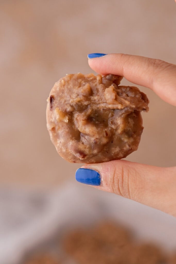 New Orleans pralines recipe patty being held up by a hand