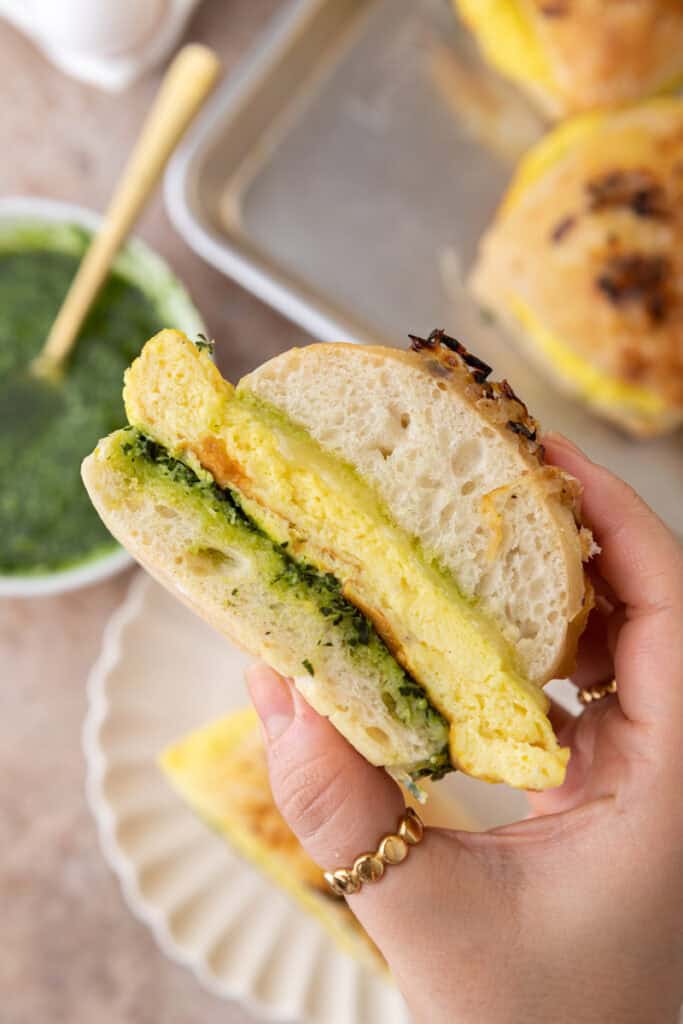 Starbucks Egg Kale Pesto Mozzarella Sandwich recipe being held up by a hand