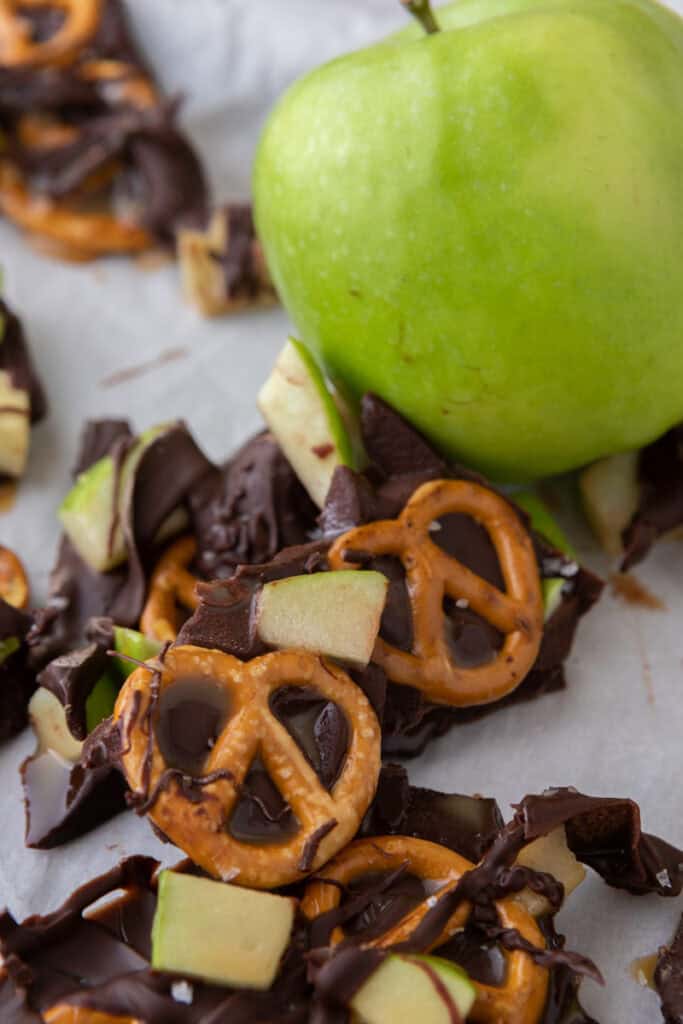 caramel apple bark recipe next to an apple