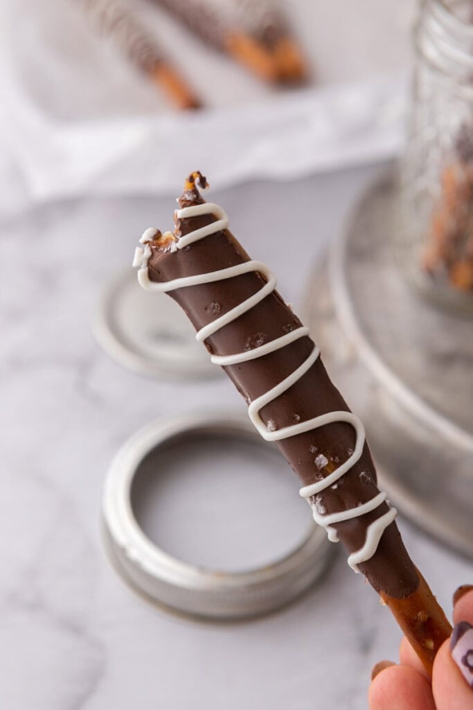 close up of a caramel chocolate covered pretzel rod