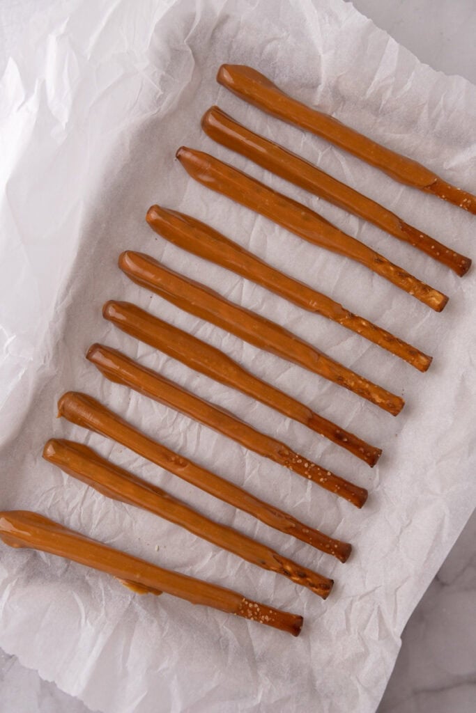 candy coated sticks resting on a sheet