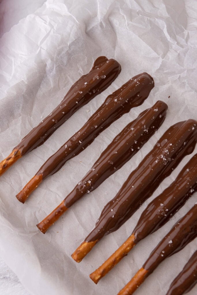 candy coated sticks resting on a sheet