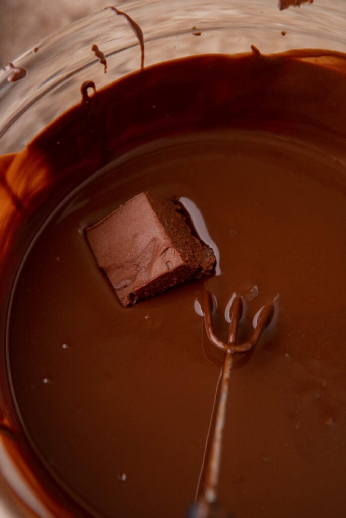 a square being dipped into melted chocolate