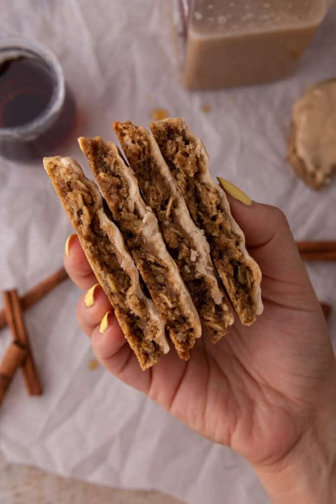 maple glazed oatmeal cookies being held up by a hand