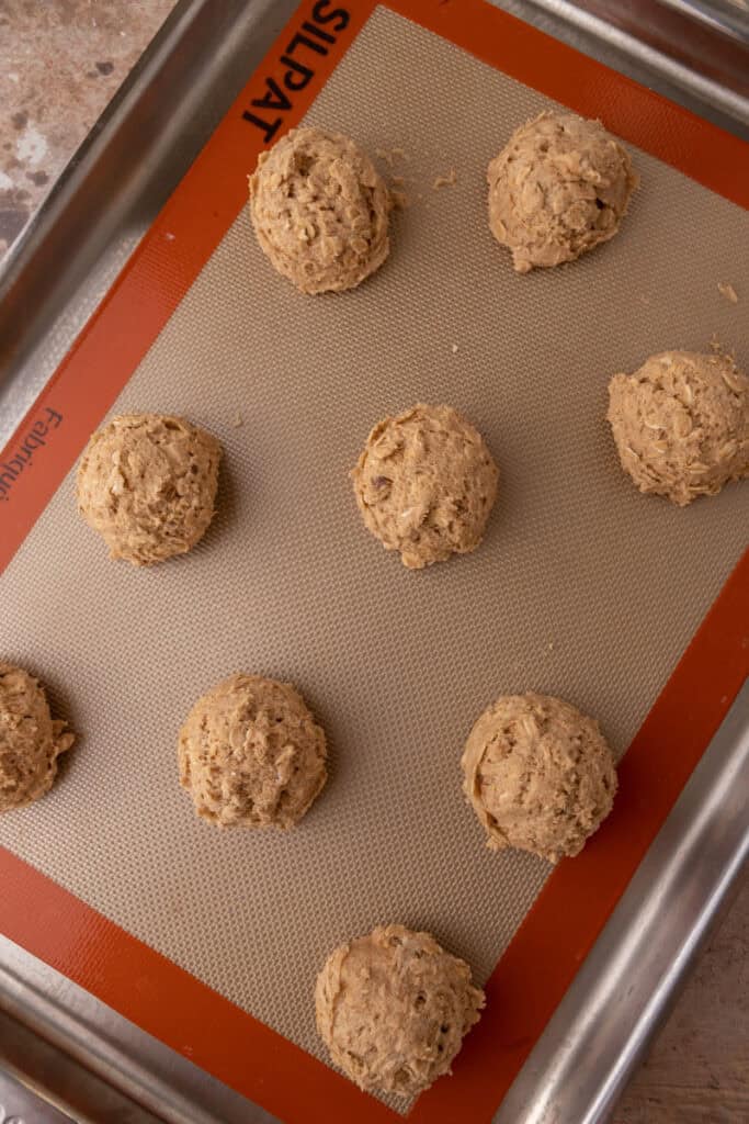 raw balls of dough on a baking sheet