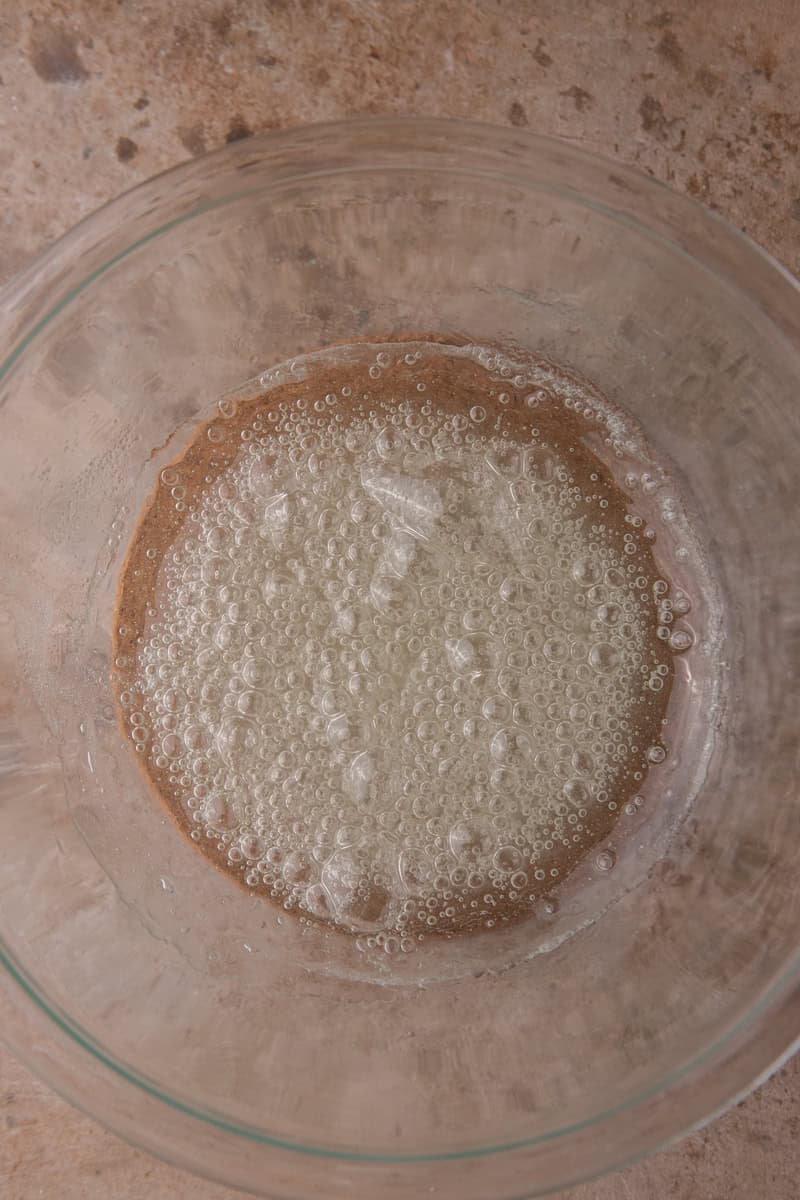 Bubbly sugar syrup in a glass bowl after the first round in the microwave.