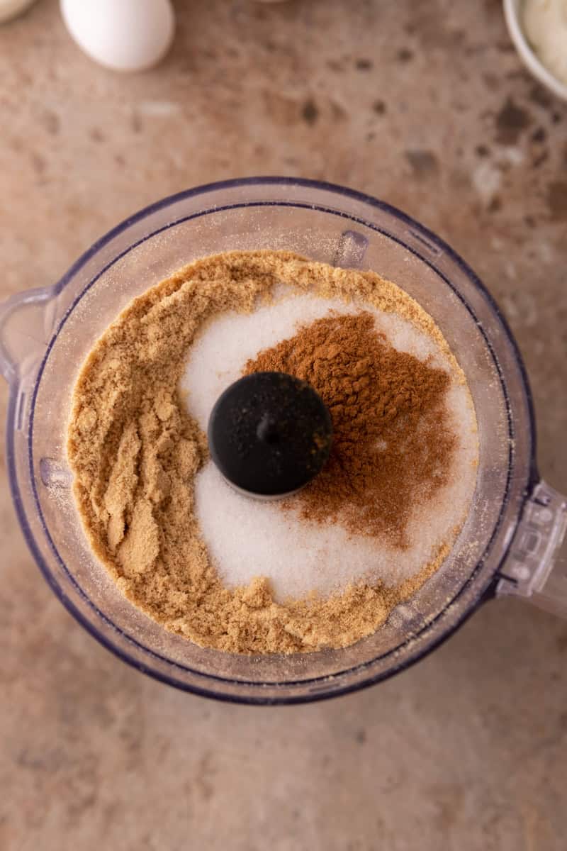 Graham cracker crumbs, sugar, and cinnamon in a food processor for the apple crisp cheesecake crust.