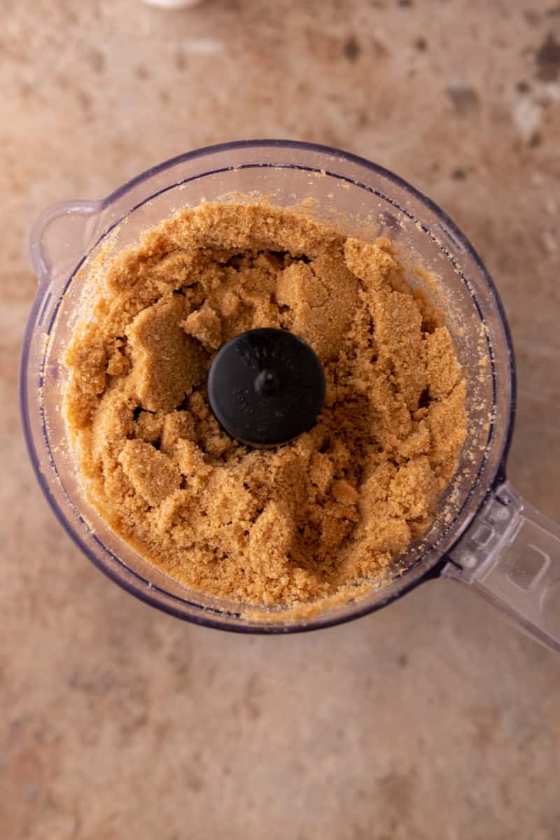 Graham cracker crust mixture pulsed with melted butter in a food processor.