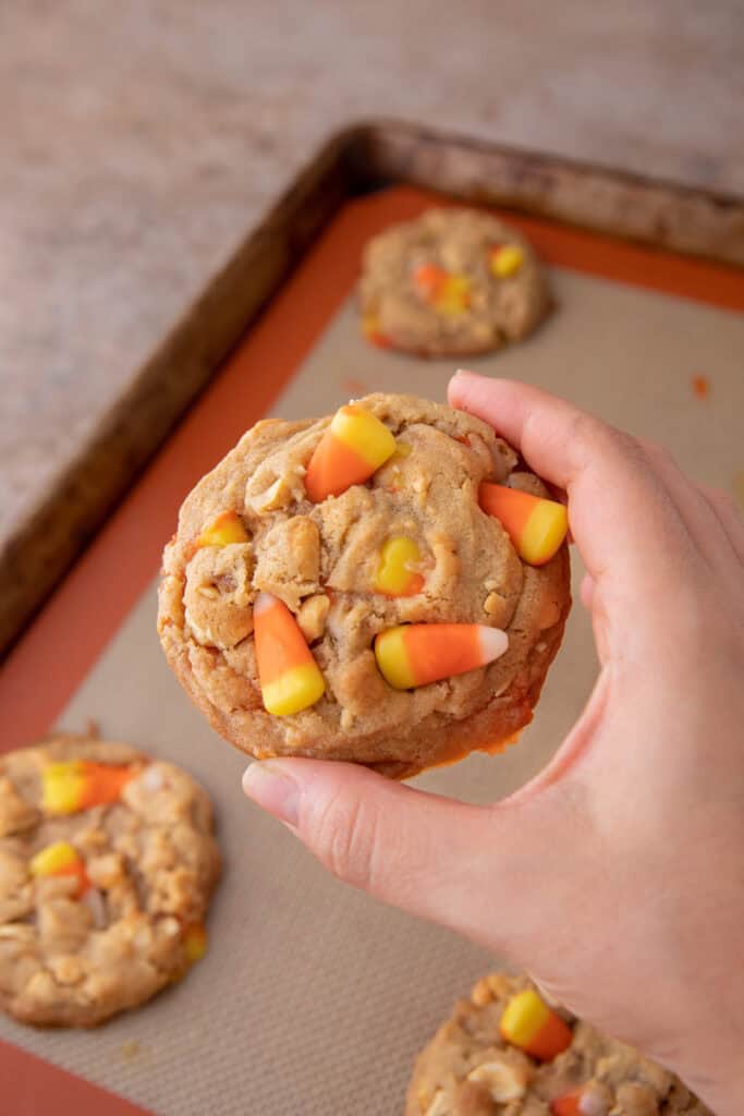 candy corn cookies recipe being held up by a hand