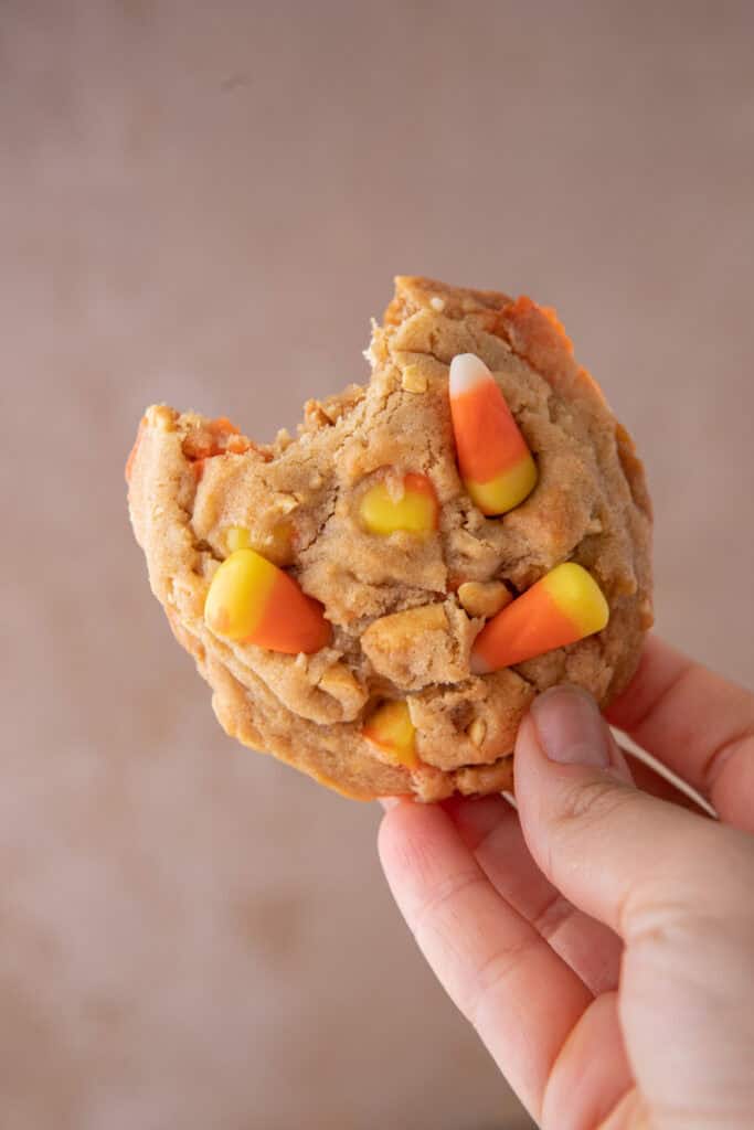 candy corn cookies recipe being held up by a hand