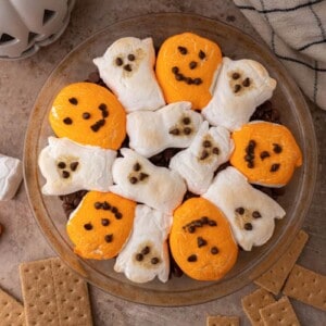 chocolate chips in a baking dish with marshmallows on top fully baked