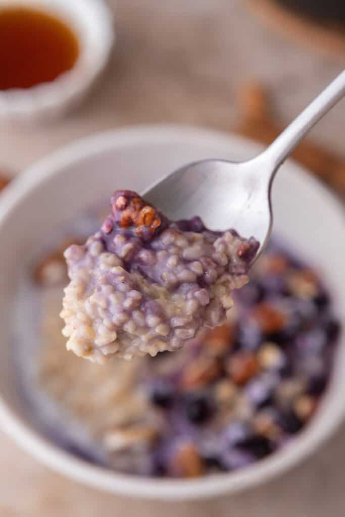 how to cook steel cut oats in instant pot being held up by a spoon