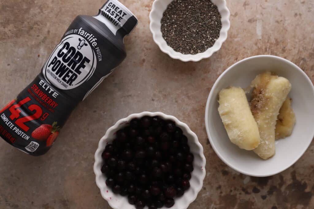 Blueberry protein shake recipe in a cup with a straw