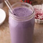 Blueberry protein shake recipe in a cup with a straw