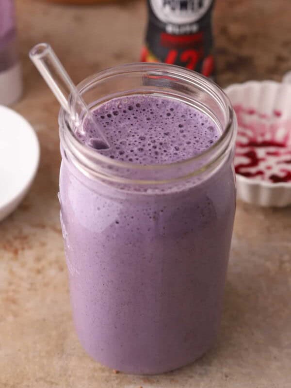 Blueberry protein shake recipe in a cup with a straw