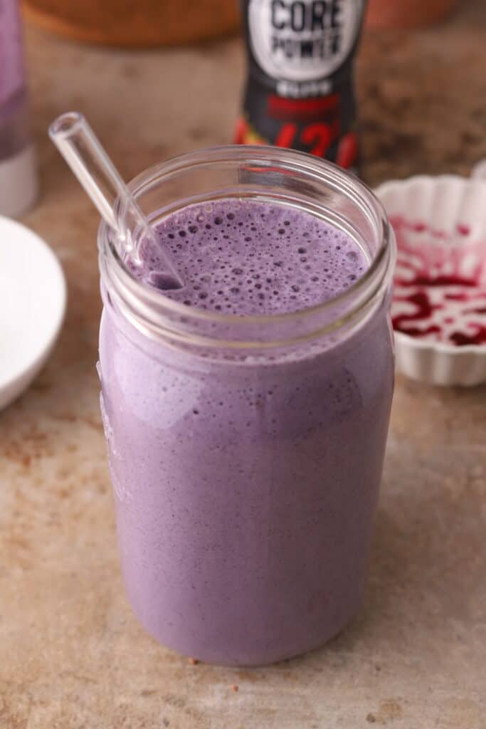 Blueberry protein shake recipe in a cup with a straw