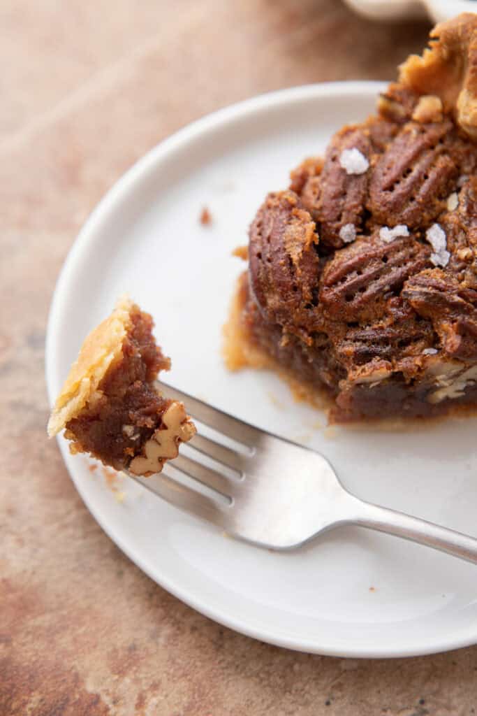 overhead shot of the maple pecan pie slice with a piece on a fork