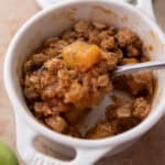 Microwave Apple Crisp for One recipe in a mug with a spoon