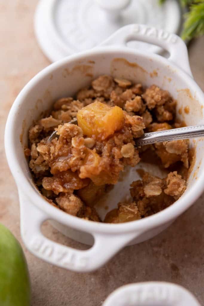 Microwave Apple Crisp for One recipe in a mug with a spoon