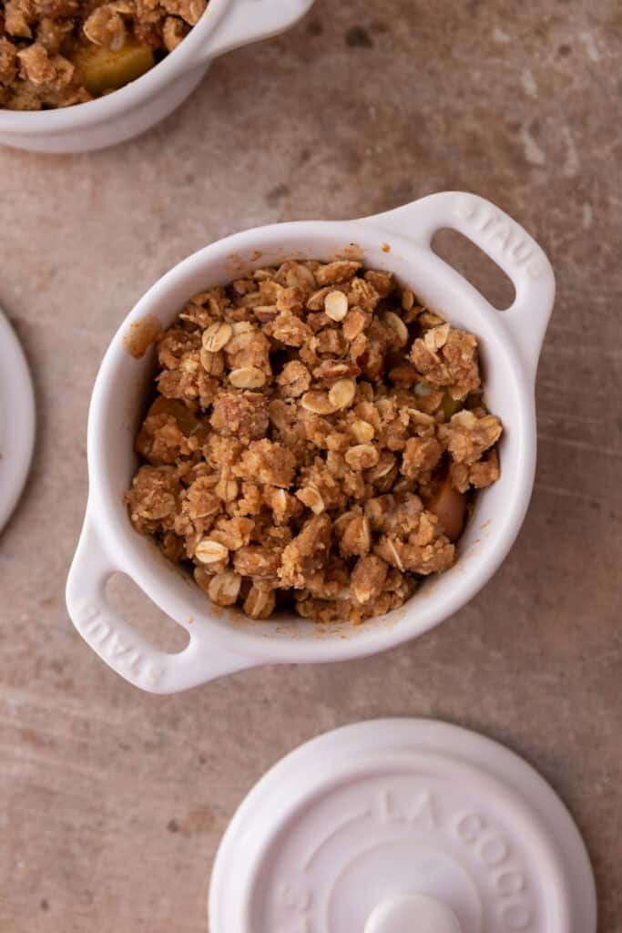 mixed topping ingredients on top of filling ingredients in a mug