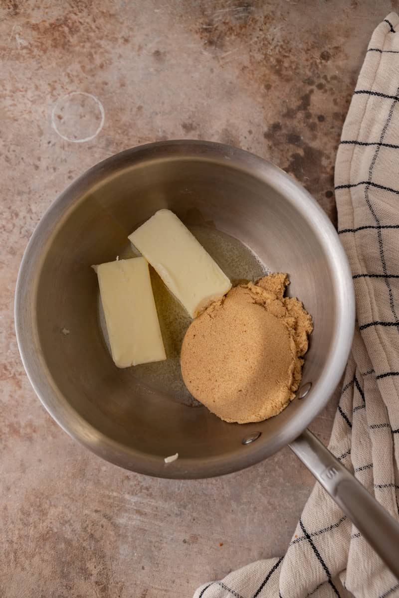 Butter and brown sugar in a saucepan before melting for pecan pie bark.