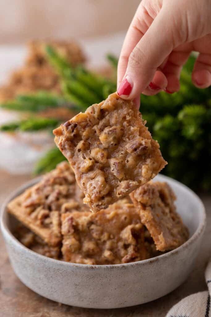 pecan pie bark recipe being held up by a hand