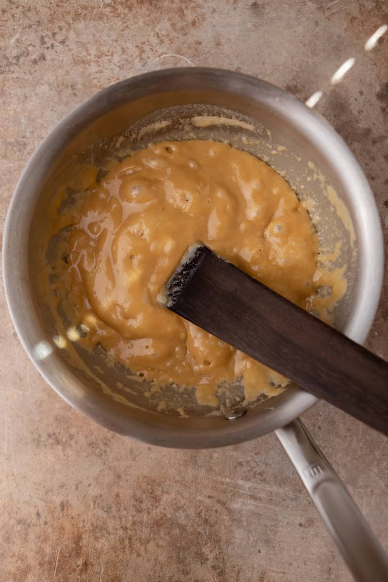 Bubbling brown sugar butterscotch in a saucepan.