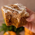 pumpkin coffee cake recipe being held up by a hand