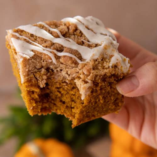 pumpkin coffee cake recipe being held up by a hand