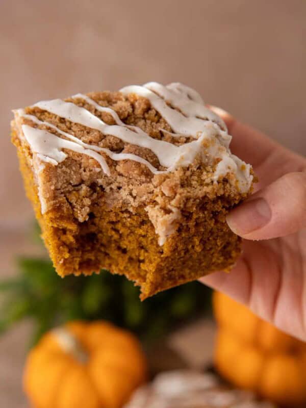 pumpkin coffee cake recipe being held up by a hand