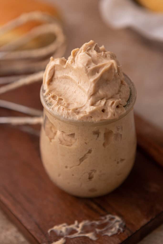 texas roadhouse cinnamon butter in a cup with a scoop taken out