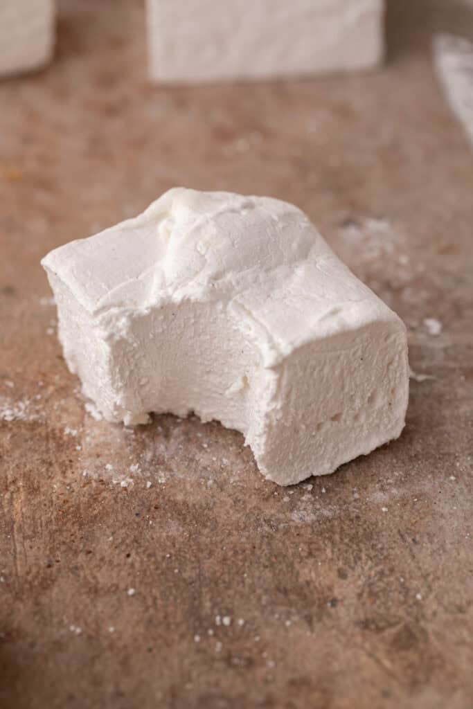 a single homemade marshmallow with a bite taken out