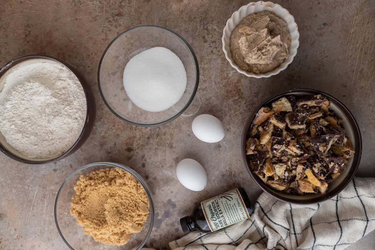 Ingredients including flour, sugars, eggs, vanilla, browned butter, and chopped Christmas crack.