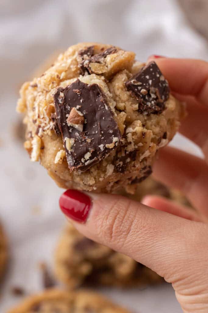 Christmas crack cookies recipe being held up by a hand