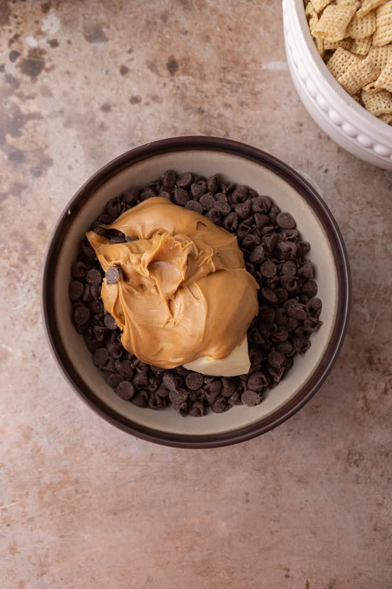 Chocolate chips, creamy peanut butter, and butter in a bowl before melting.