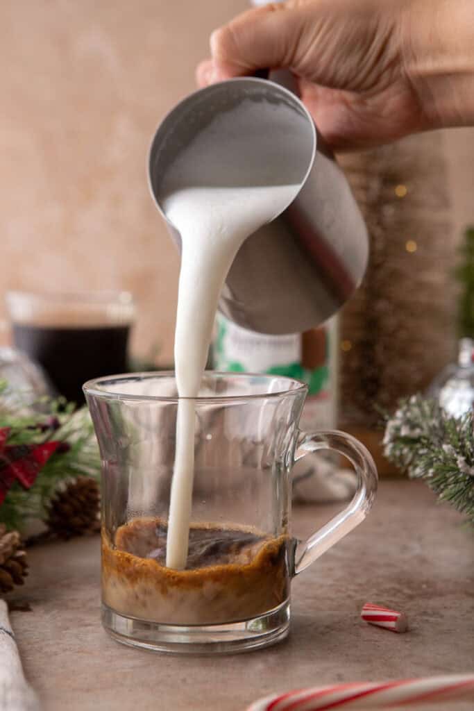 milk being poured into the cup