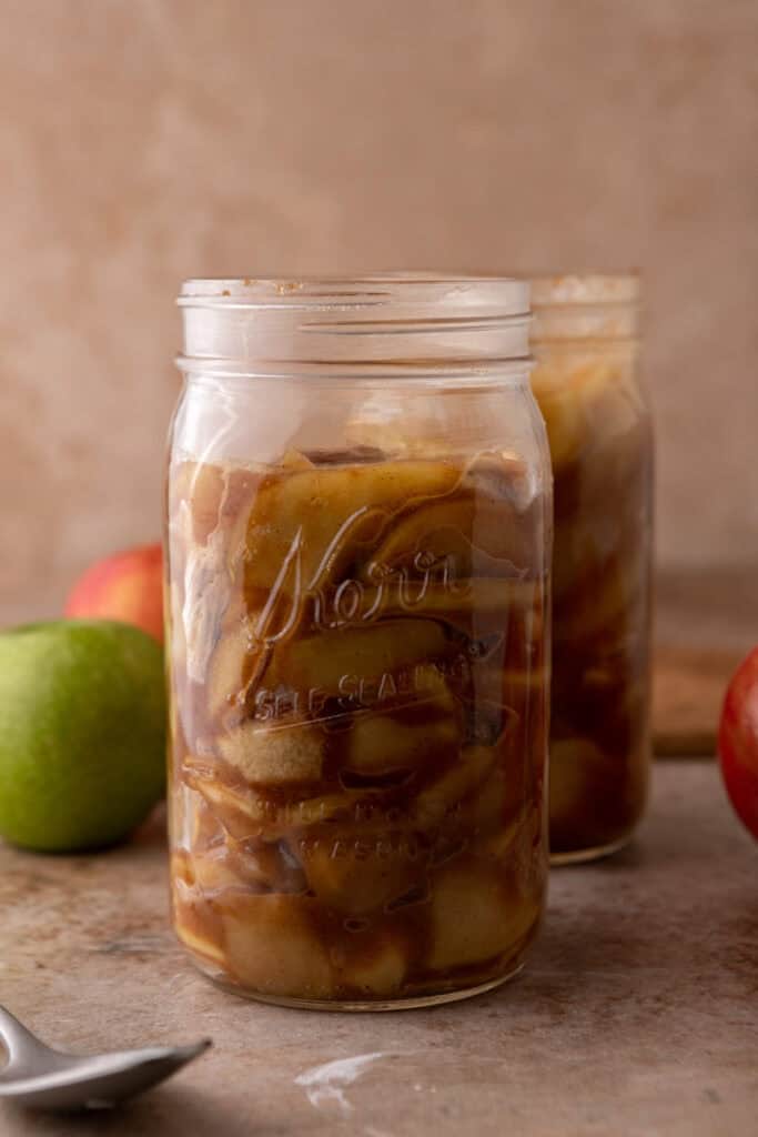 a jar full of the finished product from the how to make apple filling recipe