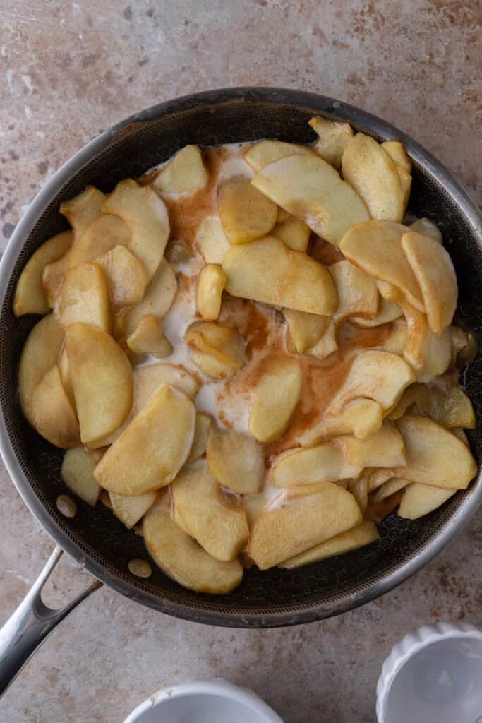 Apples cooked until tender with a mixture of cornstarch slurry mixed in the center before stirring.