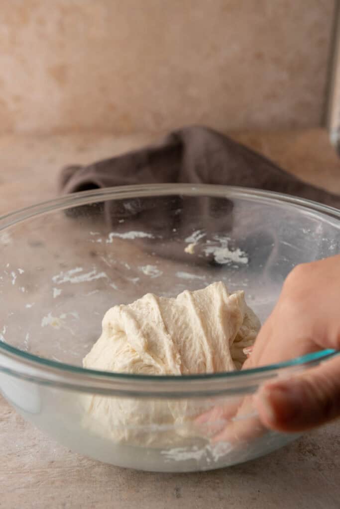 dough getting stretched and folded