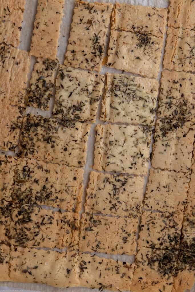 fully baked seasoned dough broken into pieces on baking sheet