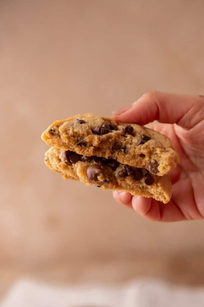 Peanut Butter Chocolate Chip Cookie being held up by hand