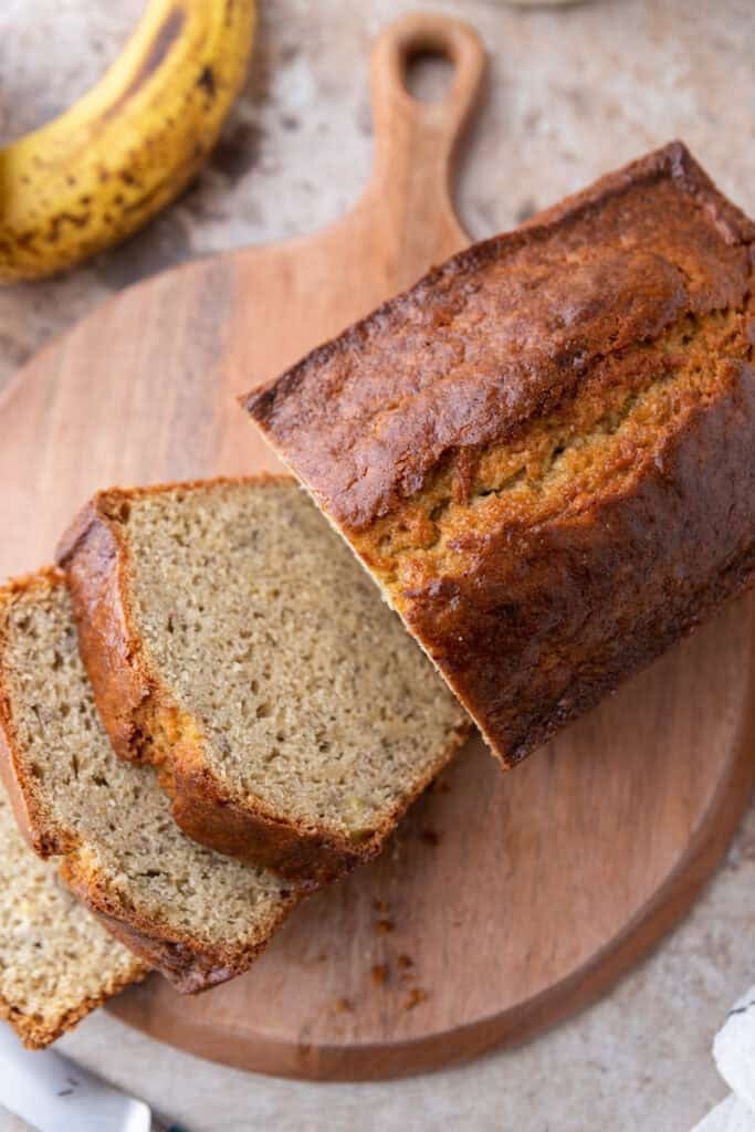 overhead shot of sourdough discard banana bread sliced up 