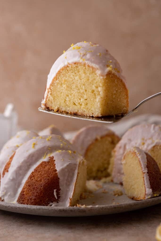 a slice of the lemon bundt cake recipe being held up