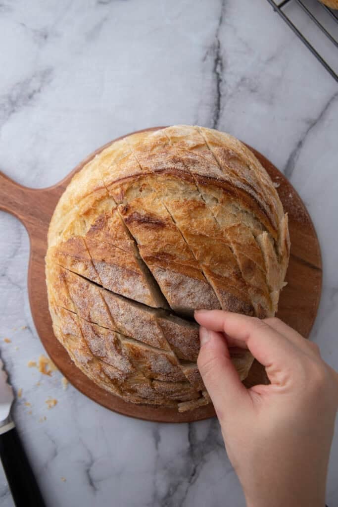 Sourdough loaf cut in crosshatch pattern before stuffing it