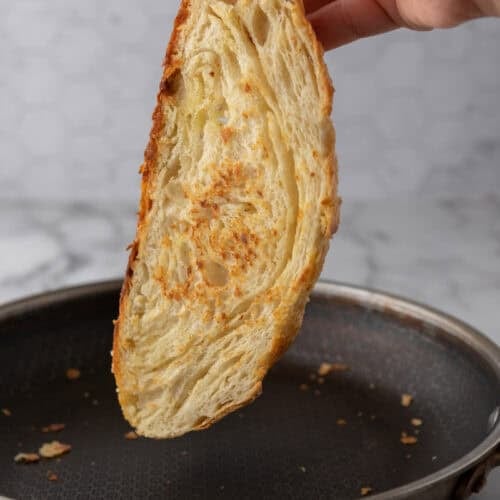 a slice of the Croissant Sourdough Bread Recipe being toasted