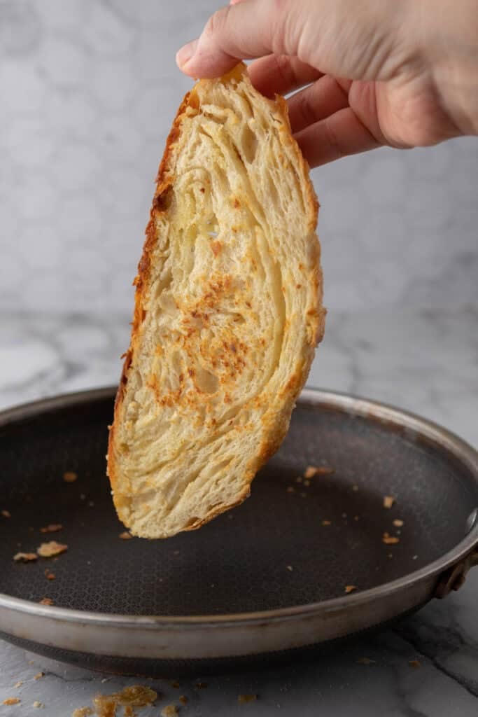 a slice of the Croissant Sourdough Bread Recipe being toasted